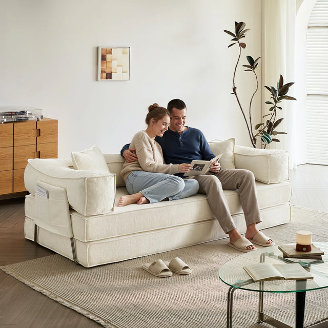 Beige modulaire slaapbank in een woonkamer, met twee personen op de bank