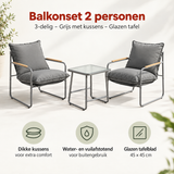 Balkonset voor 2 personen van BukkitBow, 3-delig met grijze stoelen, kussens en glazen tafel op balkon.