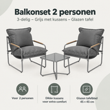 Balkonset voor 2 personen van BukkitBow, 3-delig met grijze stoelen, kussens en glazen tafel, geschikt voor buitengebruik.